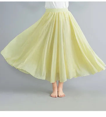 Pale yellow flowing midi skirt with an elasticated waistband and flared, lightweight chiffon-style fabric.