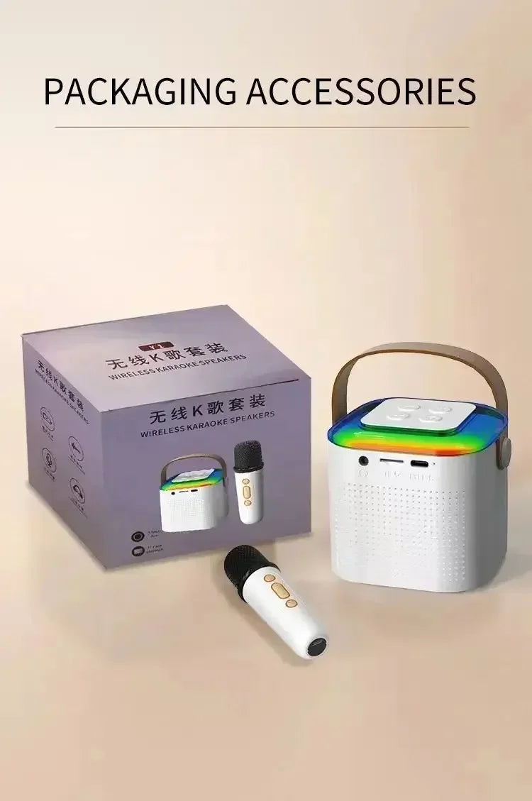 White wireless karaoke speaker with a carry handle, multicoloured RGB top light, and two matching handheld microphones.