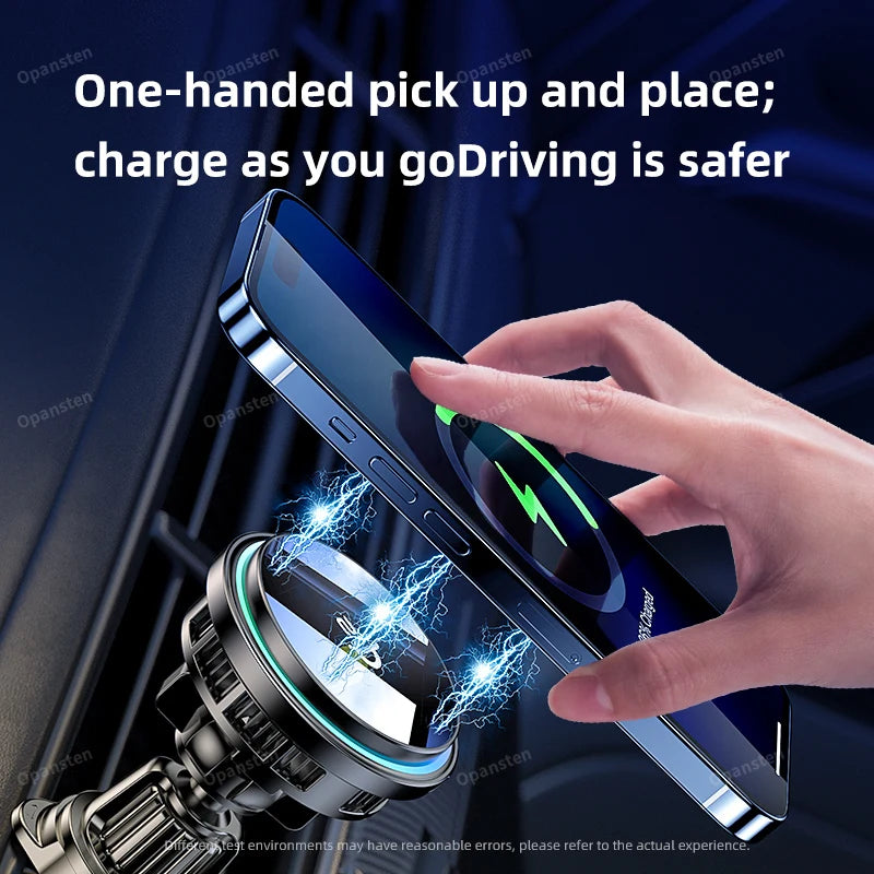 A black magnetic car phone mount attaches to a vent, wirelessly charging a smartphone held by a hand.