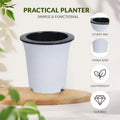 White and black self-watering flowerpot with a double-layer design on a wooden board. Highlights features in circles.