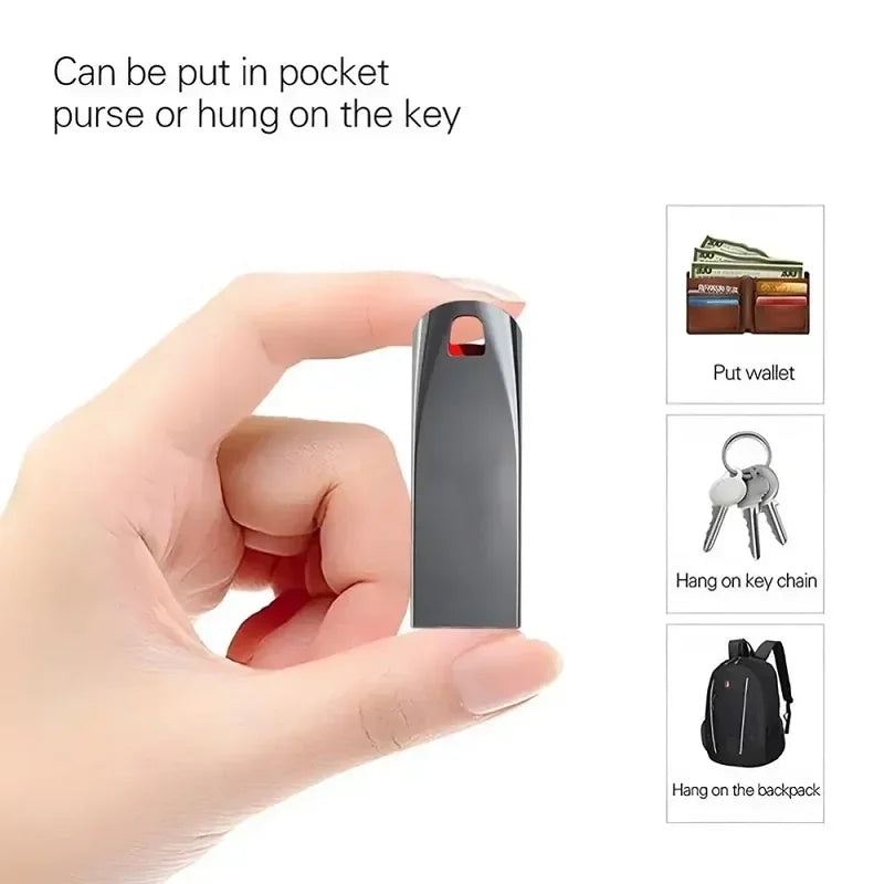 A sleek, metallic grey USB flash drive held in hand, featuring a loop for keychains and a compact, portable design.