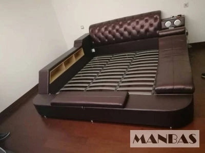 Dark brown, tufted upholstered platform bed with integrated storage shelving, built-in speakers, and slatted base.