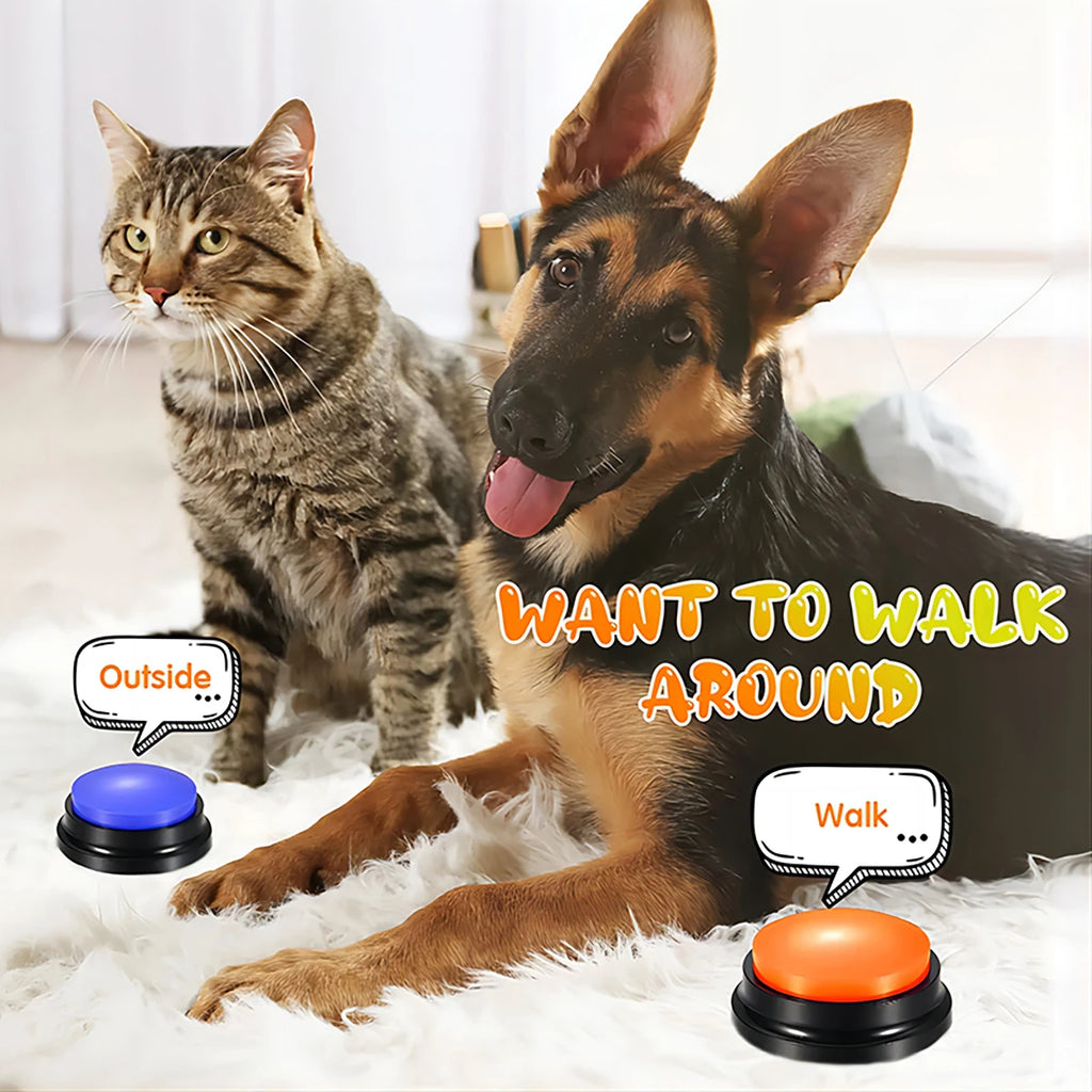 A German Shepherd and a tabby cat with blue and orange interactive recordable training buttons on a white rug.