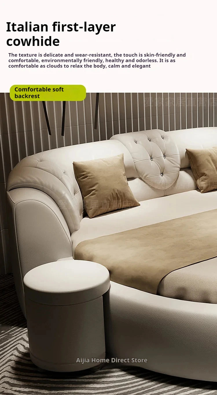 Modern, cream-coloured round double bed with an upholstered, tufted backrest and an integrated side table.