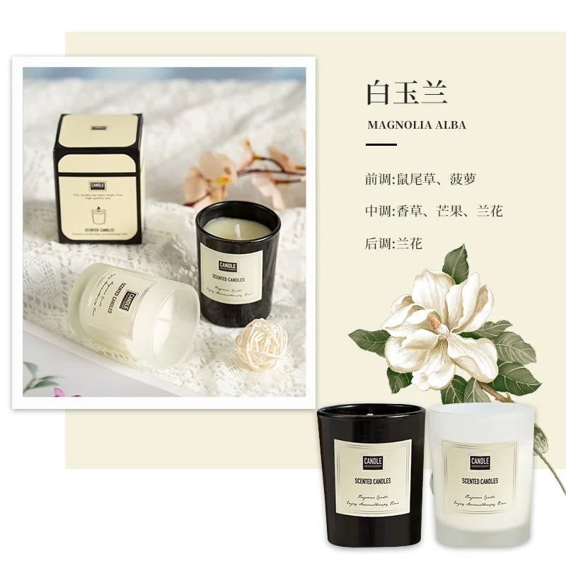 Black and frosted white scented candles in glass jars, displayed with elegant packaging and magnolia floral imagery.