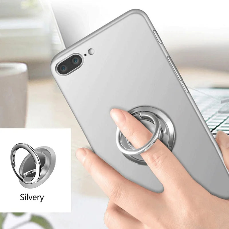 Silver ring phone holder attached to the back of a silver smartphone, being used as a finger grip for stability.