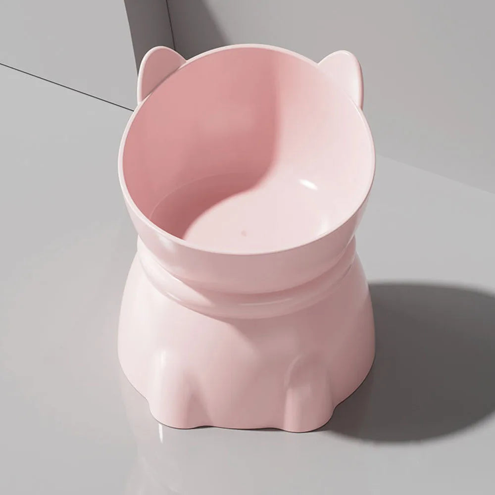Pastel pink, elevated cat-shaped pet bowl with ergonomic tilted design for comfortable feeding.