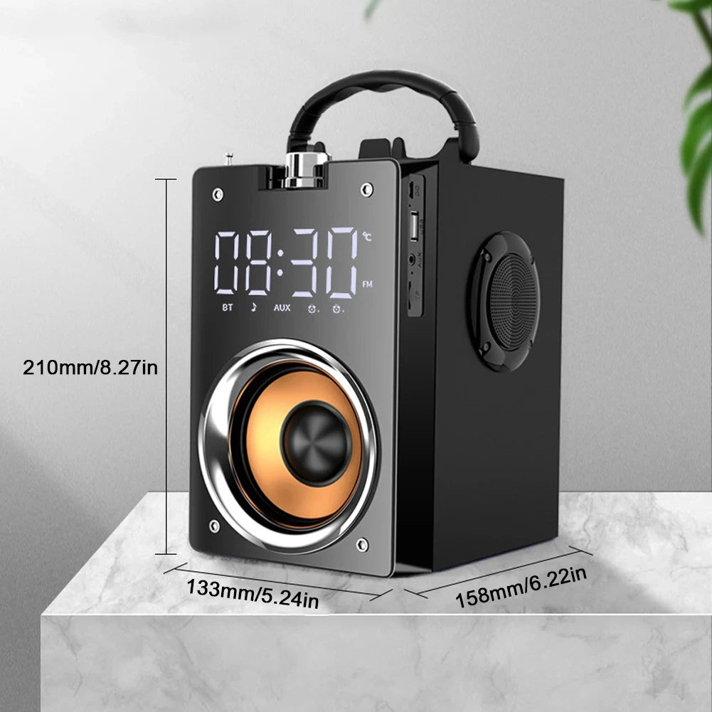 Portable black wireless speaker with digital display, top handle, and prominent copper-coloured speaker cone.