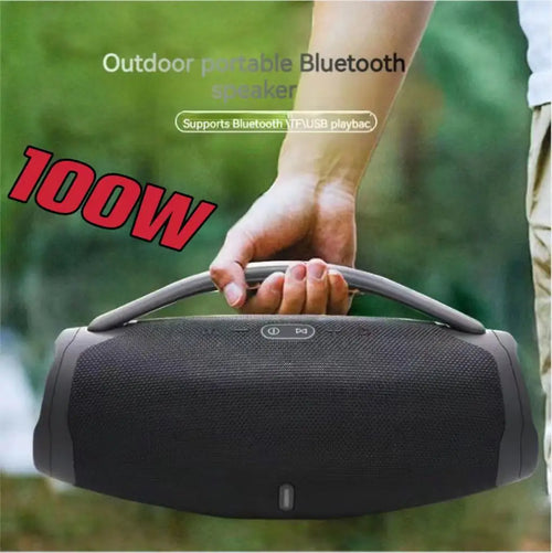 A person holds a black, portable 100W waterproof Bluetooth speaker with a sturdy carry handle.