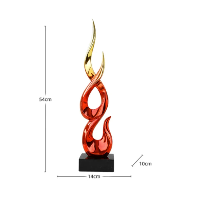 Modern abstract resin sculpture in glossy red and gold, featuring a flame-like design on a black rectangular base.