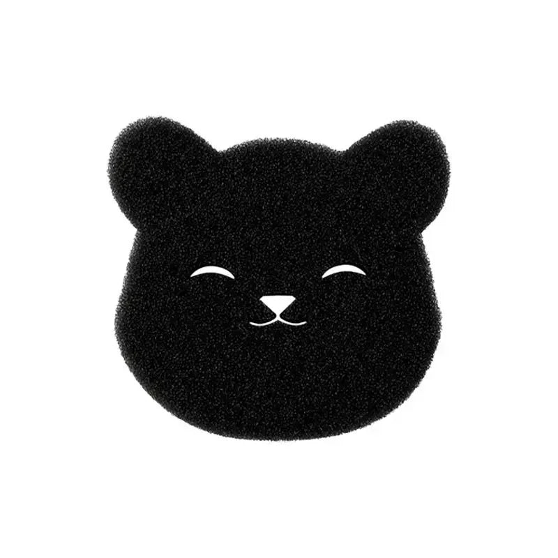 Black bear-shaped facial sponge with a white printed sleepy face.