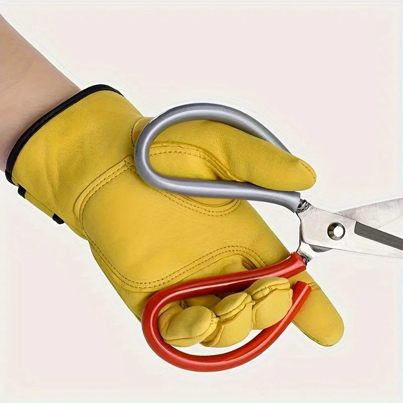 Yellow PU leather work glove with a black cuff, shown being worn while holding a pair of large garden shears.