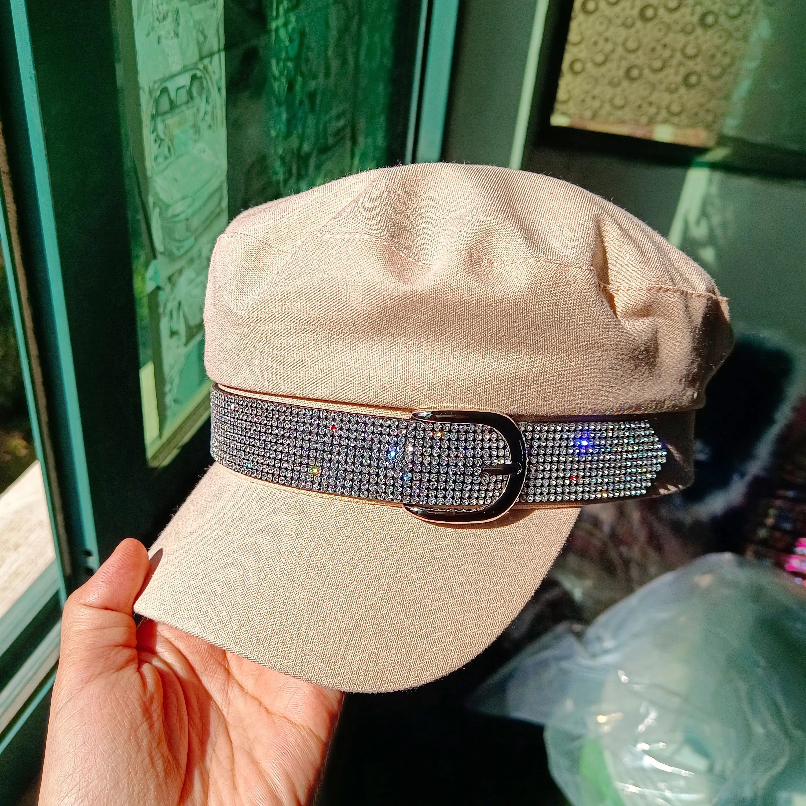 Beige military-style cap featuring a decorative sparkly rhinestone belt detail across the front.