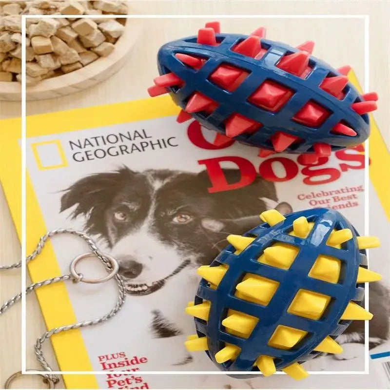 Two blue rubber rugby ball dog toys featuring textured, spiky red and yellow inserts on a magazine background.