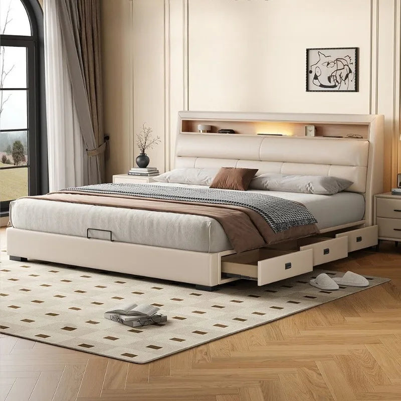 Cream leather upholstered bed frame with an integrated headboard shelf, ambient lighting, and under-bed storage drawers.