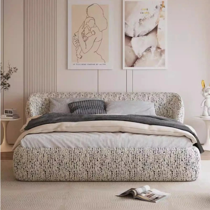 Modern bed frame with a curved, wrap-around headboard upholstered in a cream and black textured fabric.