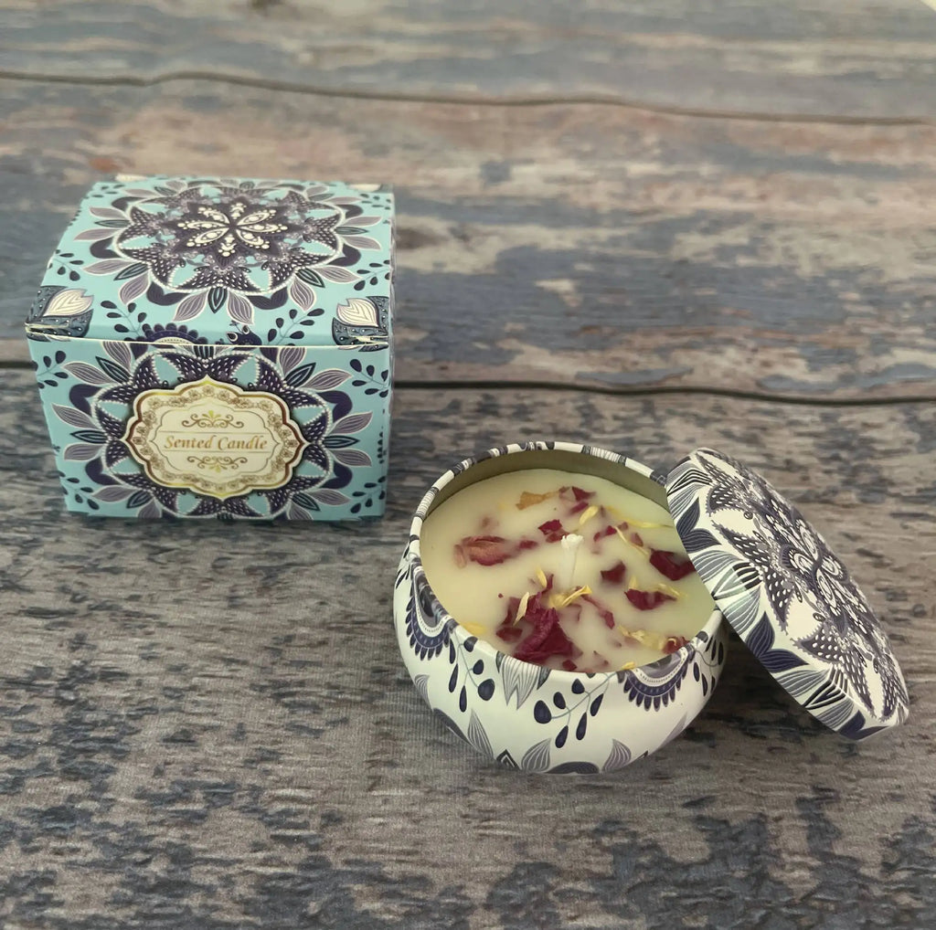 Scented candle in a decorated tin and matching box, featuring floral petals and a blue and white mandala pattern.