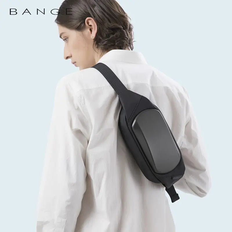 A sleek, black waterproof chest bag with a modern hardshell front, worn diagonally over the shoulder.