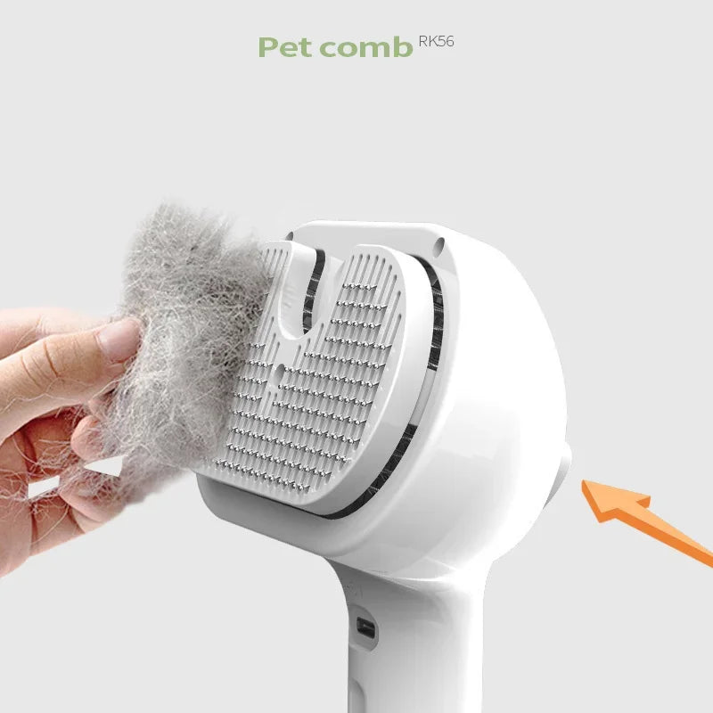 White self-cleaning pet grooming brush with fine metal bristles and a clump of removed grey fur being peeled away.
