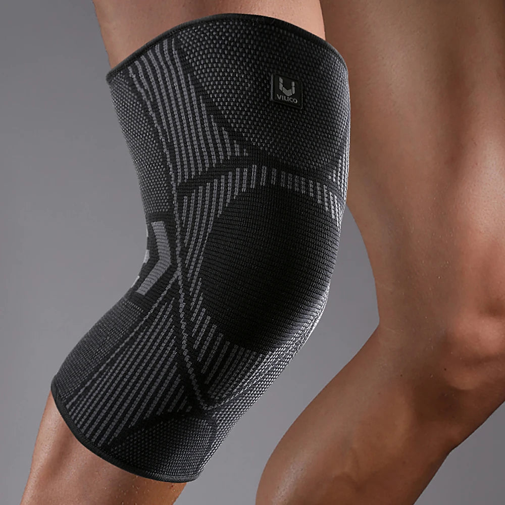 Black VILICO compression knee support sleeve with textured, breathable knit pattern worn on a bent leg.