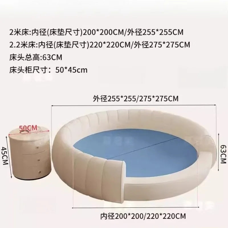 Cream-coloured minimalist round bedside table with three drawers next to a matching circular bed frame.