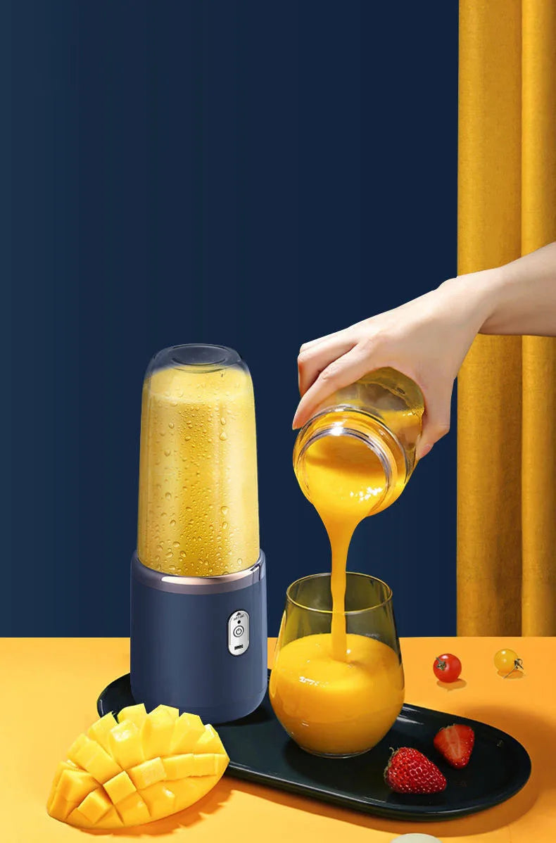 Portable dark blue blender pouring a yellow smoothie into a glass next to mango and strawberries.