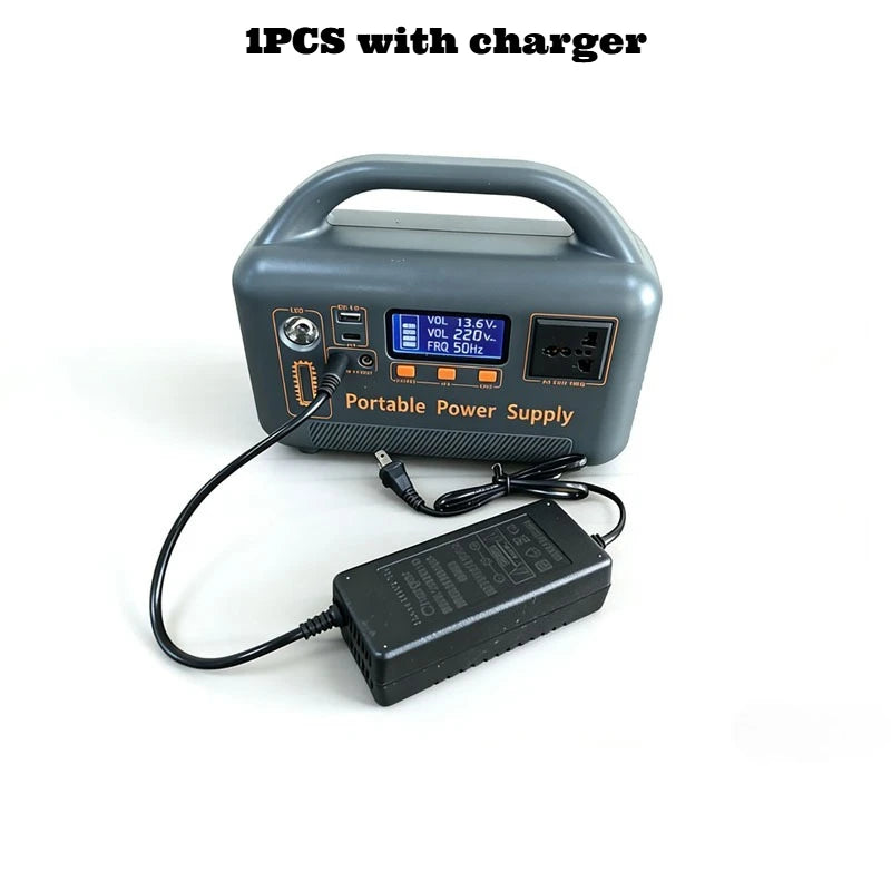 Gray portable power supply with a digital display and built-in handle, shown with its connected black power charger.