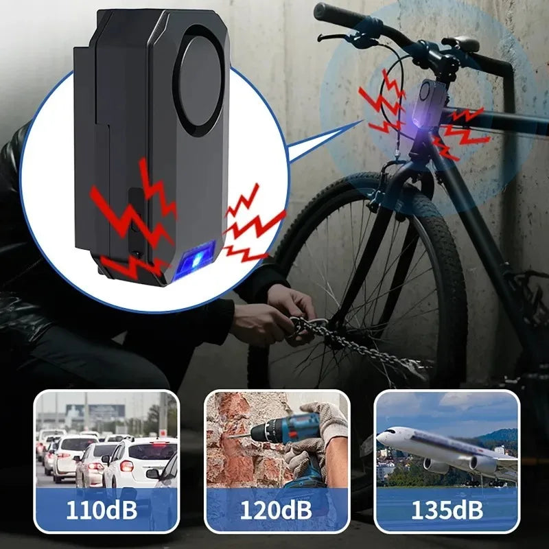 Black plastic bicycle anti-theft alarm mounted on handlebars with blue indicator light and red warning signal graphics.