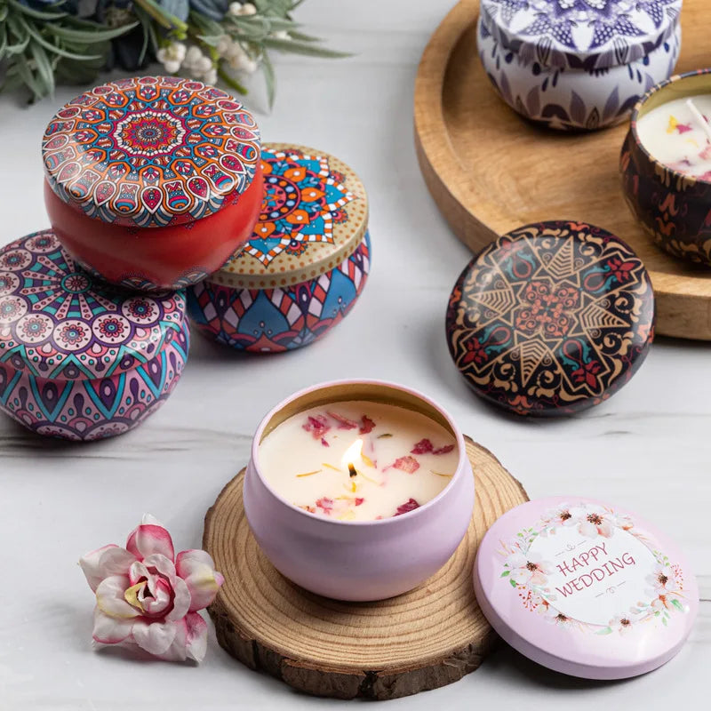 Set of decorative scented candles in colourful patterned metal tins, including a 'Happy Wedding' gift candle.