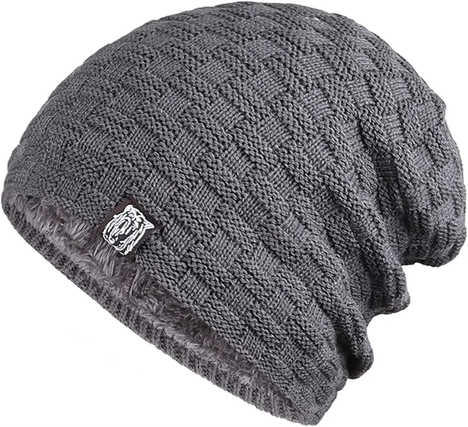 Grey, chunky-knit unisex beanie hat with a warm, plush faux-fur lining and a small rectangular tab detail.
