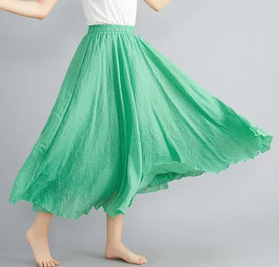 Bright green, loose-fitting midi skirt with an elasticated waistband and textured, flowing fabric.