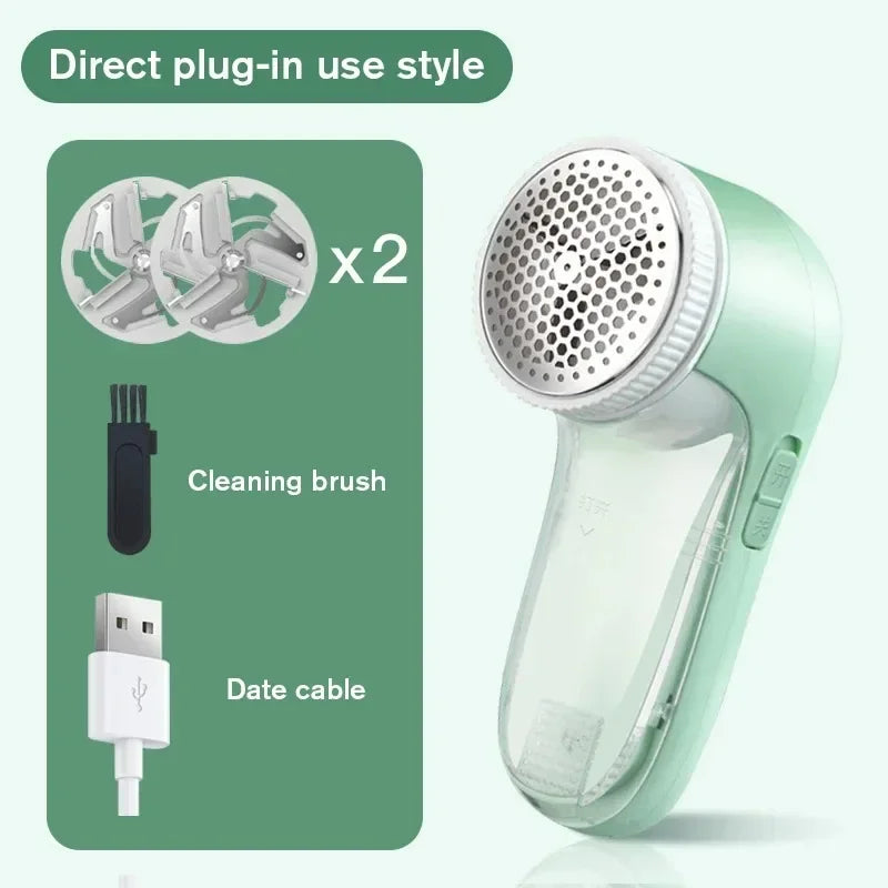 Mint green electric fabric shaver with two spare blades, a cleaning brush, and a USB charging cable.