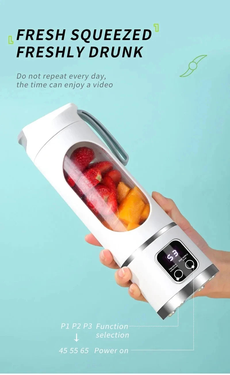 White portable electric blender with a clear fruit-filled center and a digital display on the base.