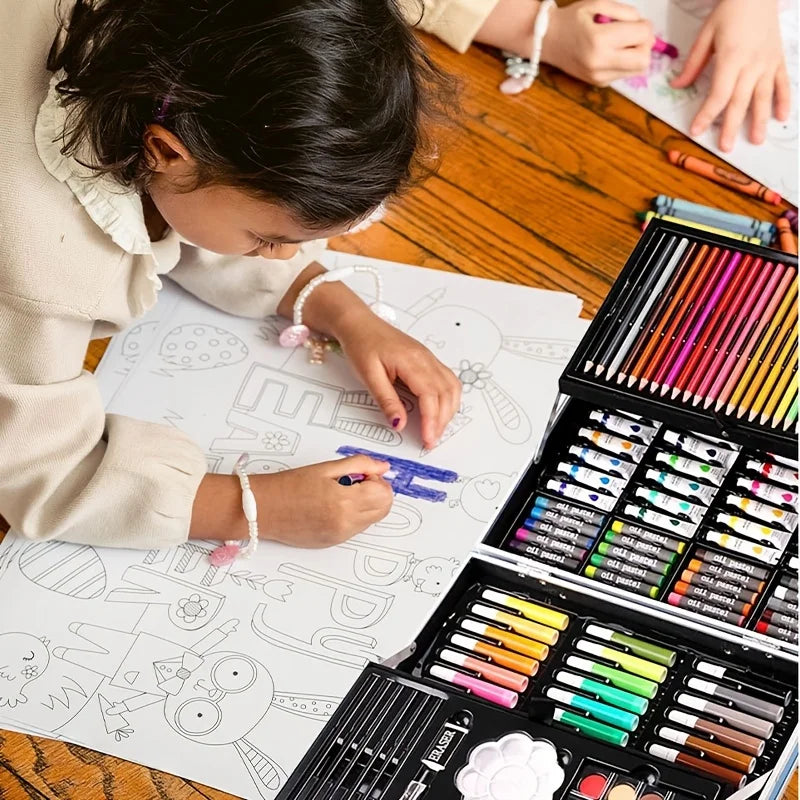 Child colouring with a comprehensive black art set featuring colourful pencils, oil pastels, paints, and accessories.