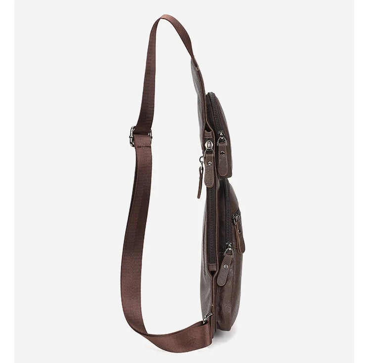 Side profile of a dark brown men’s faux leather crossbody sling bag with multiple zip pockets and adjustable strap.