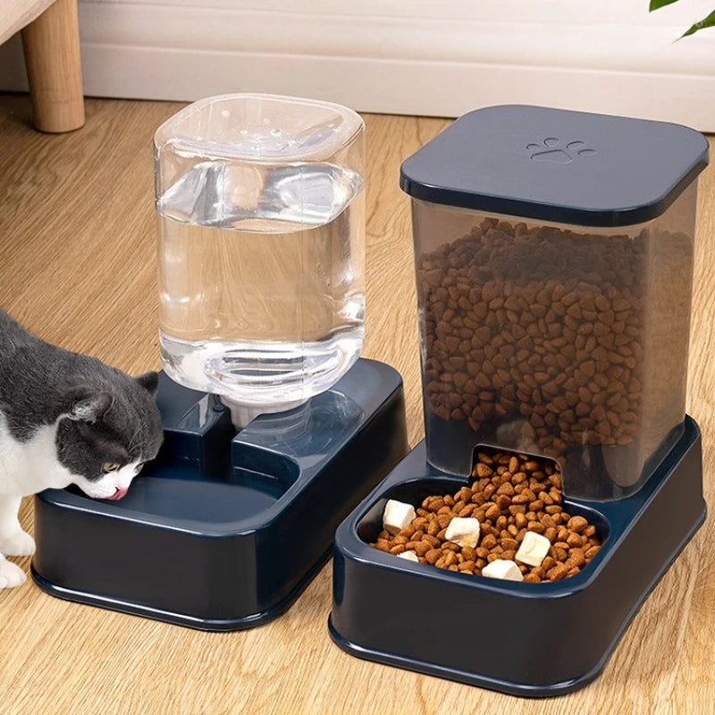 A dark blue pet water dispenser and a matching gravity food feeder with a paw print lid, sitting on a wooden floor.