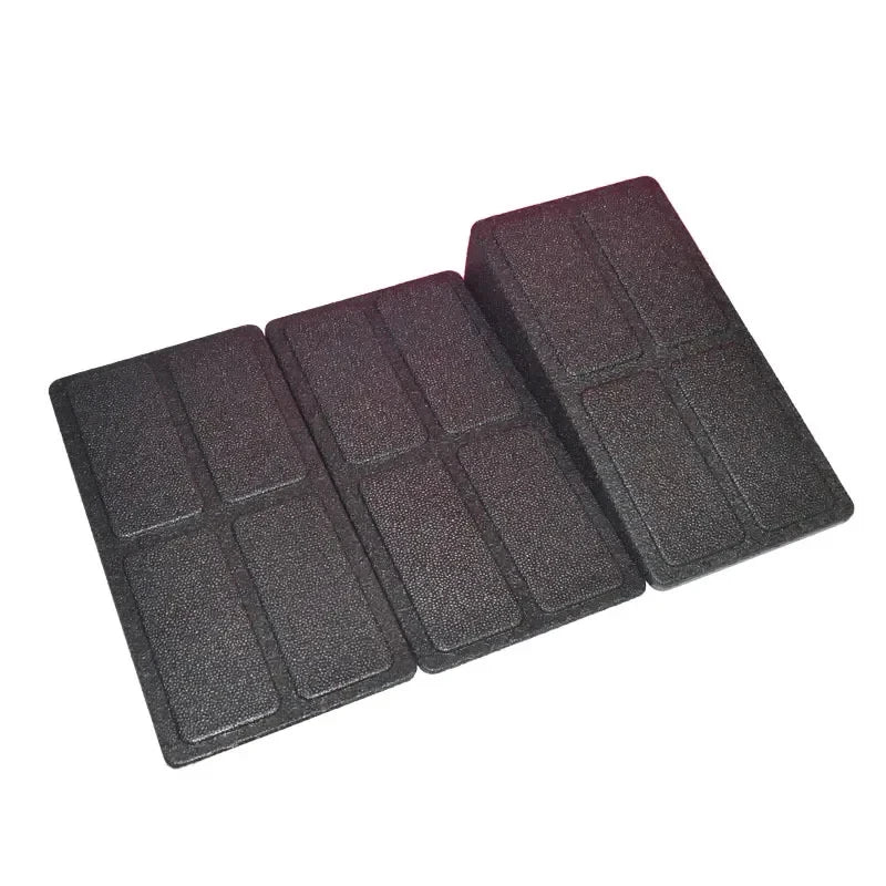 Three black foam exercise wedges, each featuring a textured surface with rectangular grid patterns.