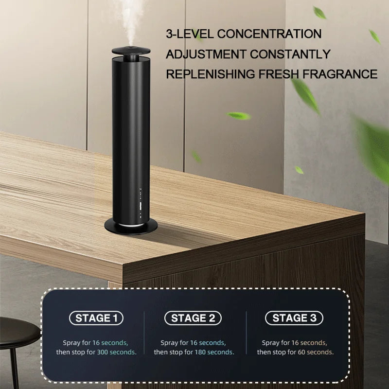 Sleek black cylindrical smart aroma diffuser on a wooden desk, releasing a fine mist with three adjustable levels.
