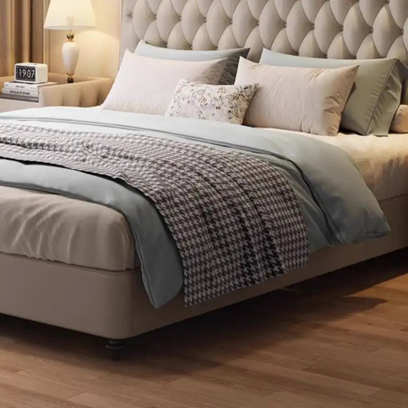 Cream upholstered queen bed frame with a button-tufted, diamond-patterned headboard and low-profile modern design.