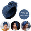 Denim blue French-style turban hat featuring a decorative top knot detail, shown on three models.