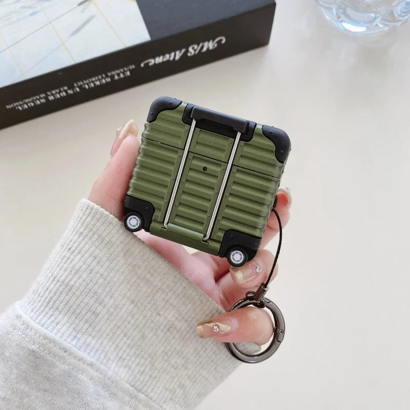 Olive green, suitcase-style hard plastic AirPod case with black corner protectors and a handy metal keyring attachment.
