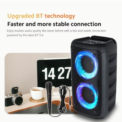 Portable black wireless speaker with glowing blue LED light rings and a wired microphone.