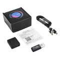 Small black plastic wireless camera with charging cable, memory card reader, box, and user manual.
