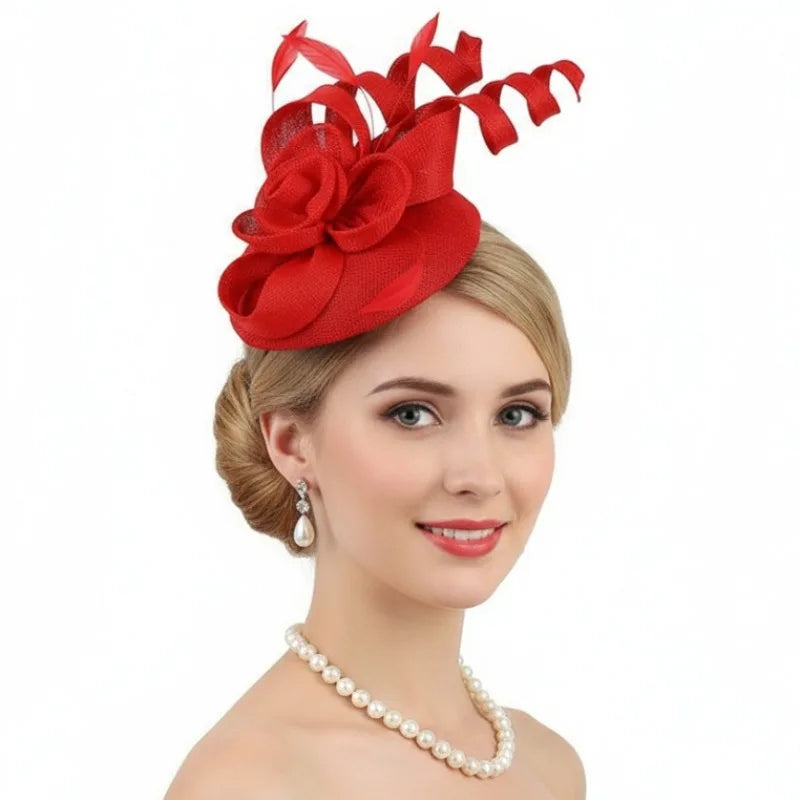 A woman wearing a vibrant red fascinator hat, styled with large fabric petals, curled ribbons, and feathers.