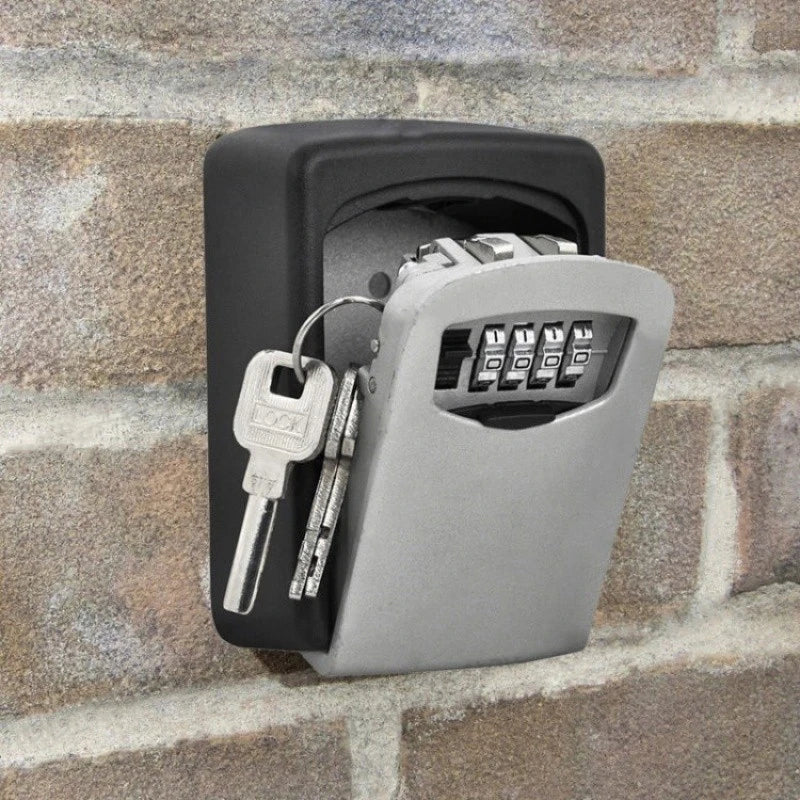 A black and silver wall-mounted key lock box with a four-digit combination dial, shown open with keys hanging inside.