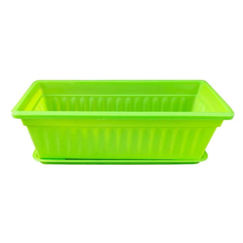 Bright green rectangular plastic planter with vertical ribbed sides and a matching drip tray, isolated on white.
