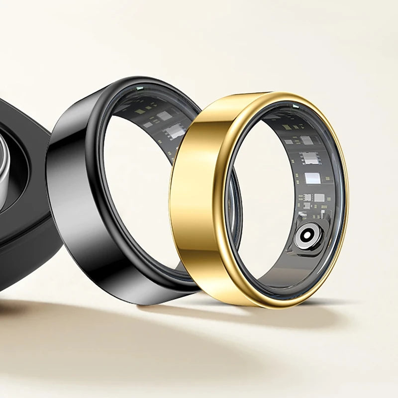 Black and gold smart fitness tracking rings with visible interior sensors and circuitry, shown on a neutral background.