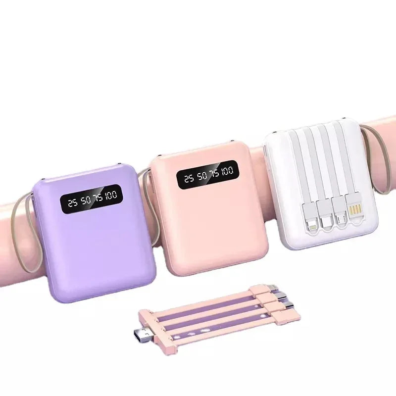 Three portable power banks in lilac, pink, and white, featuring digital displays and integrated charging cables.