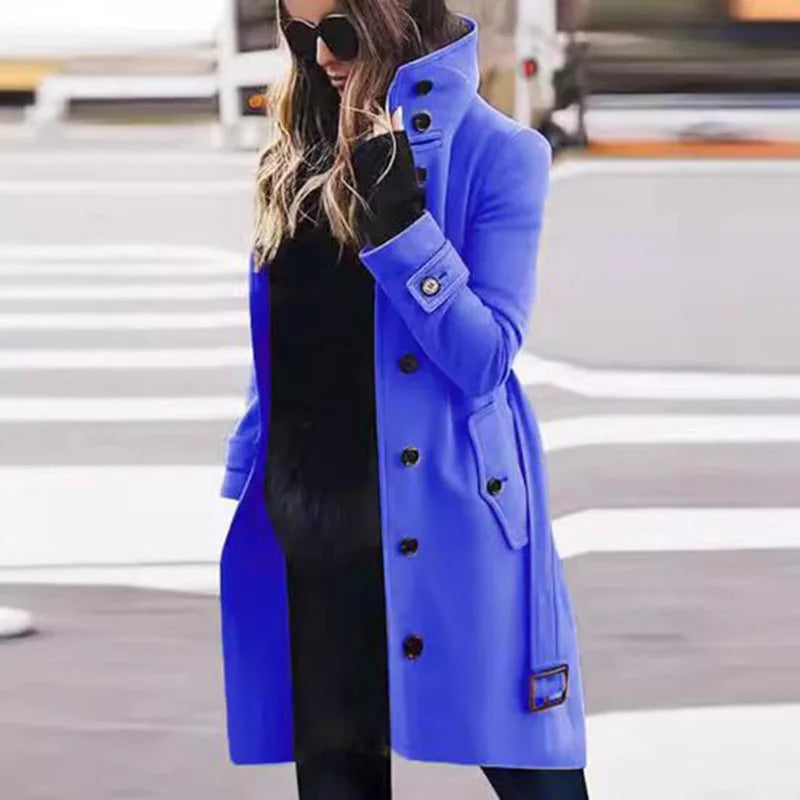 A vibrant cobalt blue wool-blend long coat with a high collar, black buttons, and belted cuffs.