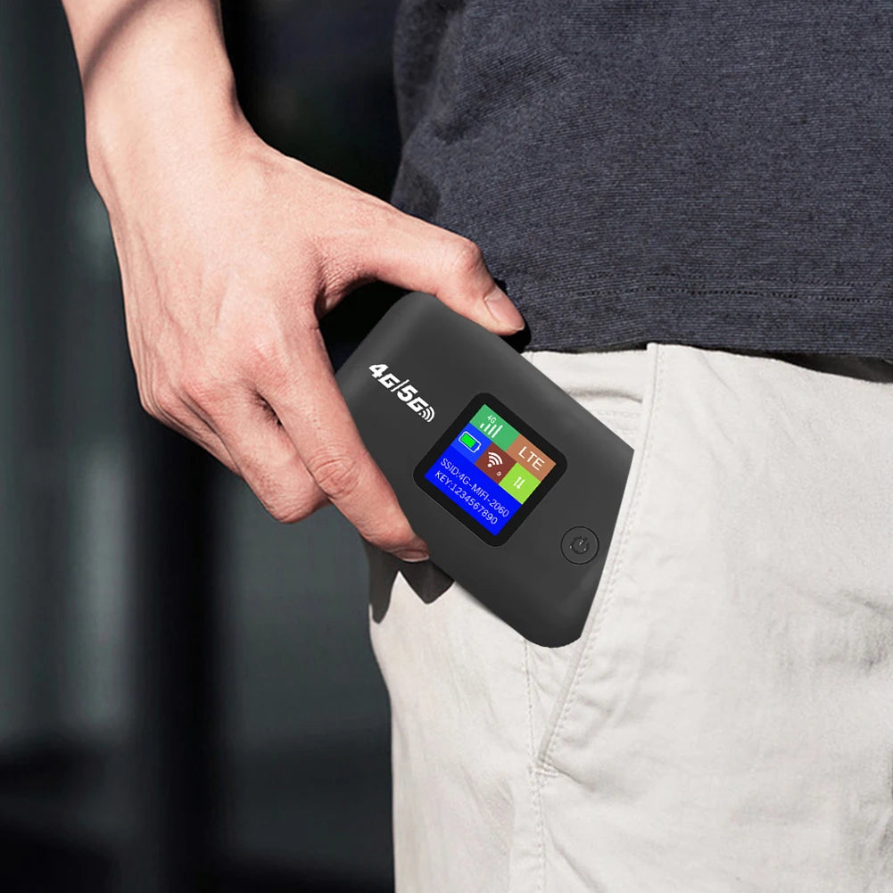 Compact black portable 4G WiFi hotspot router being held, featuring a clear status display screen.